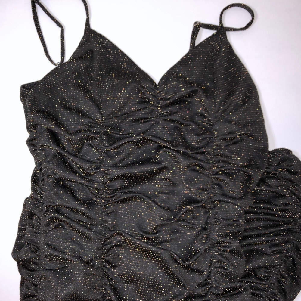 Skin tight black with gold sparkles dress